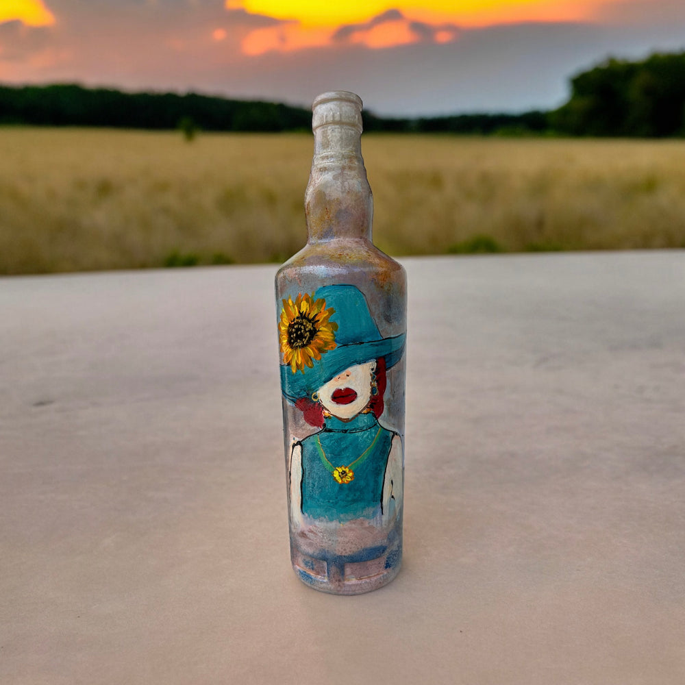 
                      
                        Hand Painted Glass Bottle - Lady in Blue hat
                      
                    