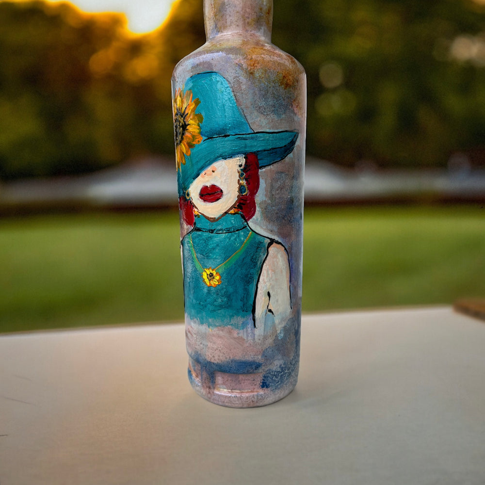
                      
                        Hand Painted Glass Bottle - Lady in Blue hat
                      
                    